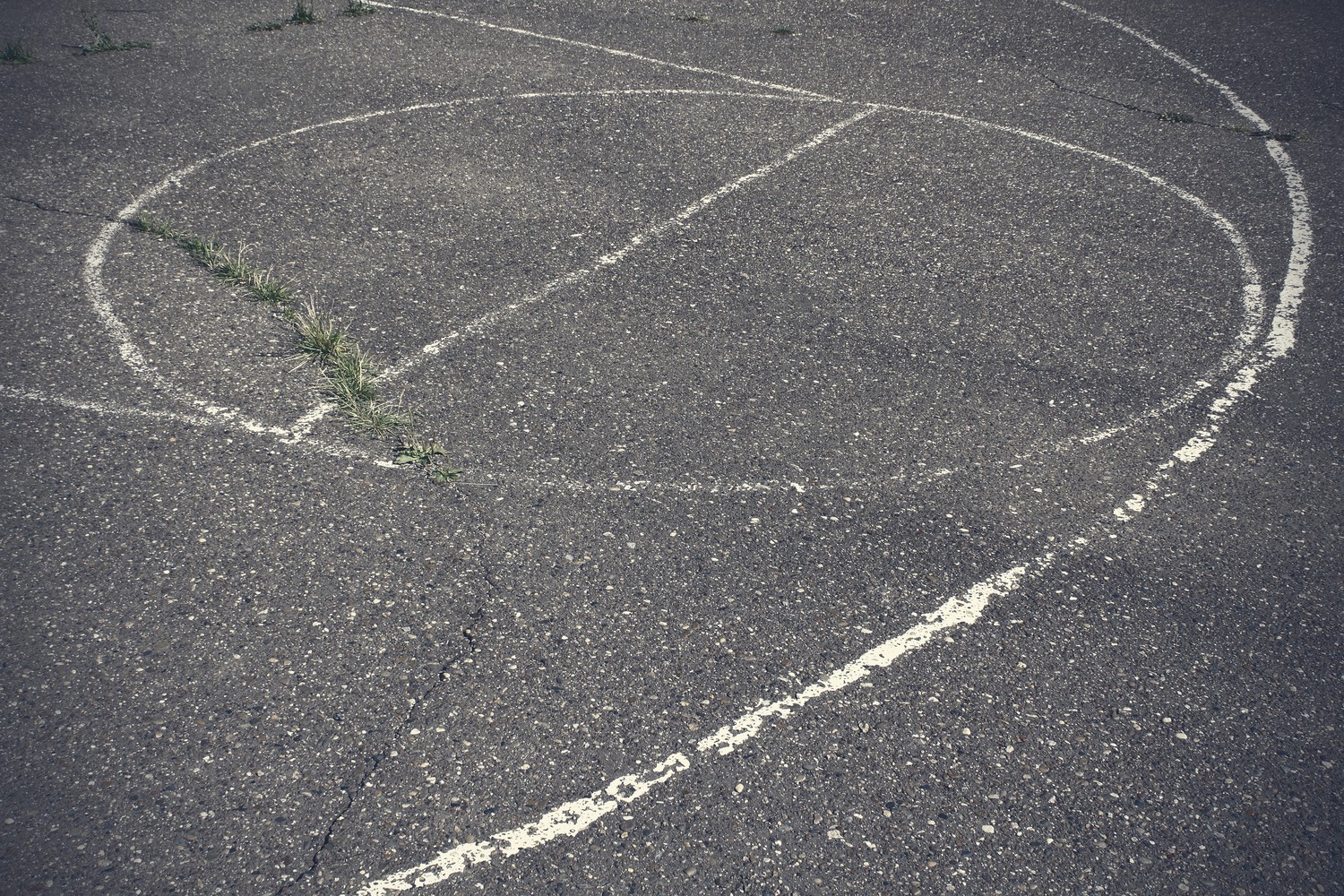 cracked school sports court paving surface before repair